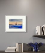 Tablou cu velier pictat manual, pe un perete gri, deasupra unor carti si a unui decor albastru