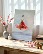 Tablou cu balerina in rochie rosie sprijinit de perete pe o masa langa fereastra, cu flori roz si vaze