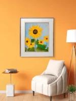 Tablou canvas Floarea Soarelui pe un perete portocaliu, langa un fotoliu alb